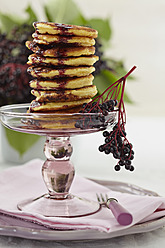 Stacked pancakes on cakestand with elderberry on plate - ECF000103