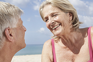 Spain, Mallorca, Senior couple sitting at beach - PDYF000208