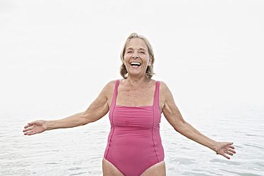 Spain, Senior woman on beach - PDYF000252