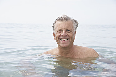 Spain, Senior man swimming in sea - PDYF000250