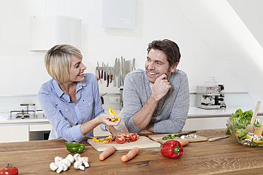 Germany, Bavaria, Munich, Mature couple in kitchen, smiling - RBYF000266