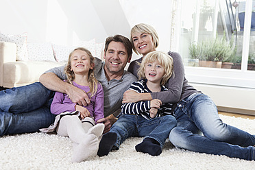 Germany, Bavaria, Munich, Family lying on floor, portrait, smiling - RBYF000311