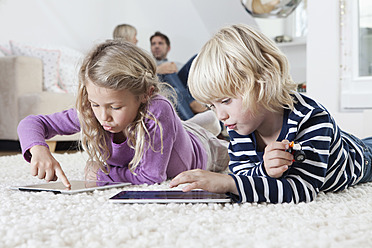 Germany, Bavaria, Munich, Boy and girl using digital tablet - RBYF000320