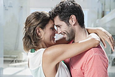 Spain, Mid adult couple embracing, smiling - WESTF018950