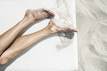Spain, Human legs on beach towel - WESTF018990