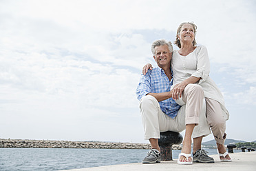 Spain, Senior couple at harbour, smiling - WESTF019045