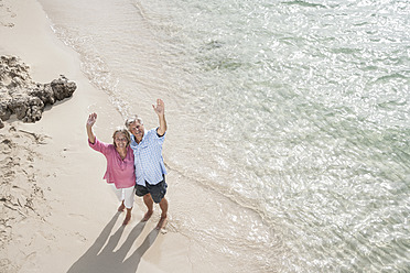 Spain, Senior couple standing on beach - WESTF019064
