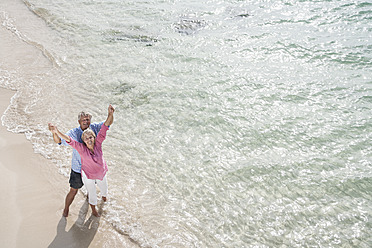 Spain, Senior couple standing on beach - WESTF019066