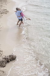 Spain, Seniors couple embracing at beach - WESTF019073