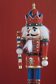 Close up of Nutcracker figurine against red background - ASF004675