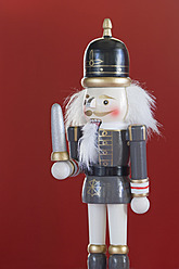 Close up of Nutcracker figurine against red background - ASF004677