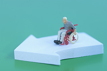 Figur im Rollstuhl mit Pfeilzeichen auf grünem Hintergrund - ASF004683