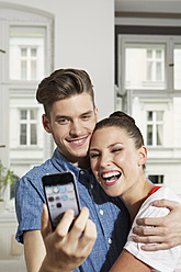 Germany, Berlin, Young man and woman taking photo of themselves - SKF000996