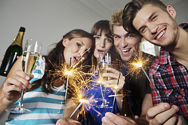 Germany, Berlin, Group of young people waving sparklers - SKF001045