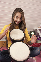 Mädchen spielt Schlagzeug, lächelnd - RNF001052