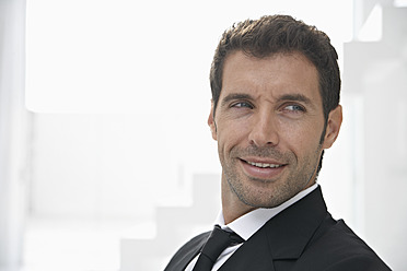 Spain, Businessman looking away, smiling - PDYF000304