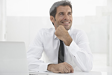 Spain, Businessman thinking, smiling - PDYF000316