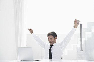 Spain, Businessman excited while looking laptop, smiling - PDYF000317