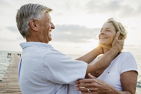 Spain, Senior couple embracing at the sea - JKF000018