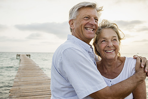 Spain, Senior couple embracing at the sea - JKF000019