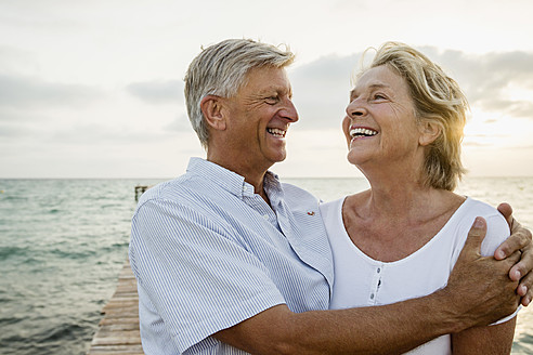 Spain, Senior couple embracing at the sea - JKF000020