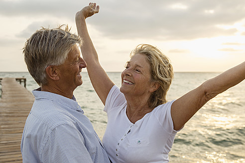 Spain, Senior couple embracing at the sea - JKF000022