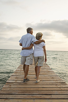 Spain, Senior couple standing on jetty at the sea - JKF000023