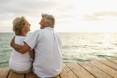 Spain, Senior couple embracing at the sea stock photo