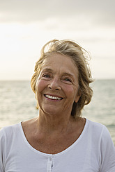 Spain, Senior woman at the sea, smiling - JKF000031