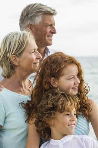 Spain, Grandparents with grandchildren atthe sea stock photo