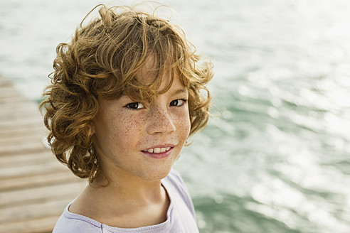 Spain, Portrait of boy at Atlantic Ocean, smiling - JKF000080