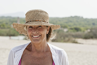 Spain, Senior woman at beach, smiling - JKF000109