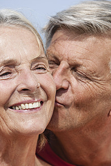 Spain, Senior man kissing to woman, close up - JKF000116