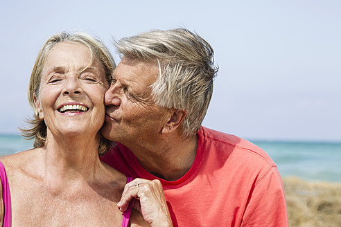 Spain, Senior man kissing to woman, close up - JKF000120