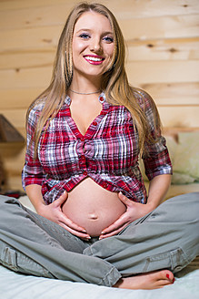 USA, Texas, Pregnant young woman holding stomach - ABAF000500