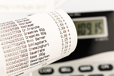 Shopping receipt for groceries with calculator, close up - EJWF000176