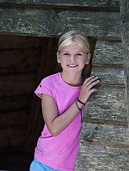 Austria, Portrait of girl standing in tent, smiling - WWF002730