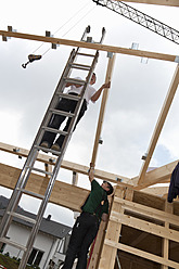 Europe, Germany, Rhineland Palatinate, Men working on roof of house - CSF016079