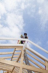 Europe, Germany, Rhineland Palatinate, Man celebrating topping out ceremony - CSF016084