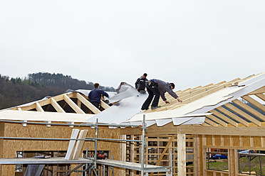 Europe, Germany, Rhineland Palatinate, Workers roofing on house - CSF016092