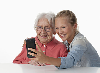 Ältere Frau und Mädchen im Teenageralter fotografieren sich selbst, lächelnd - WWF002492