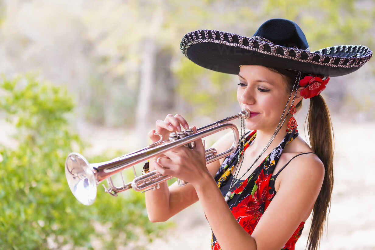 USA, Texas, Young woman playing trumpet stock photo