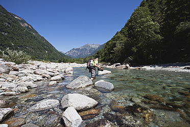 Europe, Switzerland, Mature man hiking at Verzasca River - GWF002071