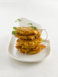 Stack of veggie burger with parsley on plate, close up - KSWF001027