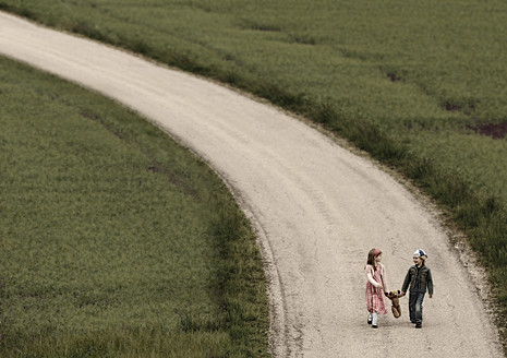 Austria, Girl and Boy walking on road with teddy bear - CW000005