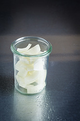 Glass of onion pieces on table, close up - EVGF000028