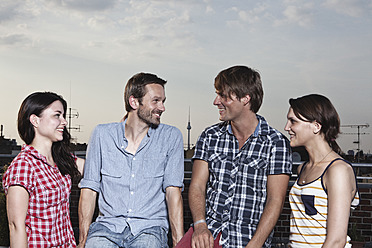 Germany, Berlin, Men and women on roof terrace, smiling - RBF001187