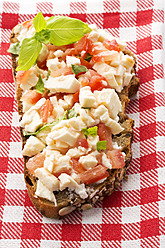 Mozzarella, tomatoes and basil on whole grain bread, close up - MAEF005608