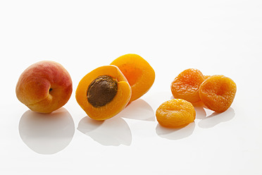 Fresh and dried apricots on white background, close up - CSF016270