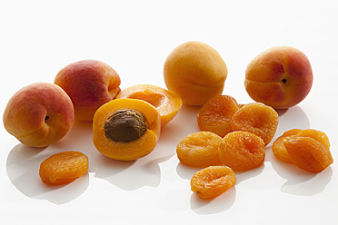 Fresh and dried apricots on white background, close up - CSF016271